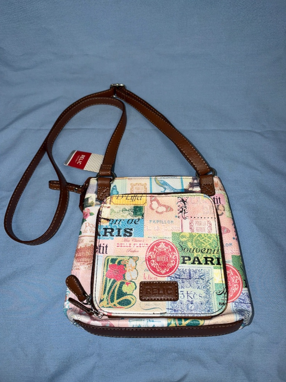 Relic crossbody bag with a Paris theme.